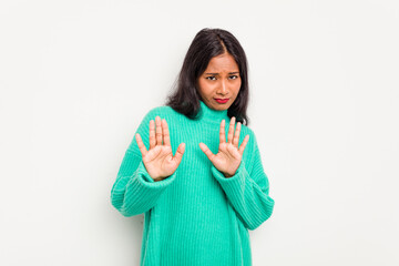 Young Indian woman isolated on white background rejecting someone showing a gesture of disgust.