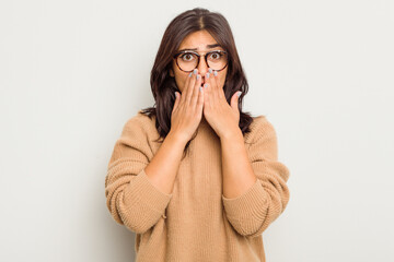 Young Indian woman isolated on white background shocked covering mouth with hands.