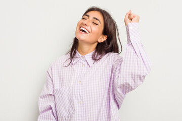 Young Indian woman isolated on white background celebrating a victory, passion and enthusiasm, happy expression.