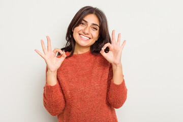 Young Indian woman isolated on white background cheerful and confident showing ok gesture.
