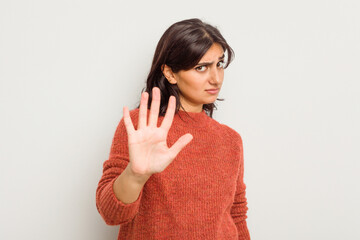 Young Indian woman isolated on white background rejecting someone showing a gesture of disgust.