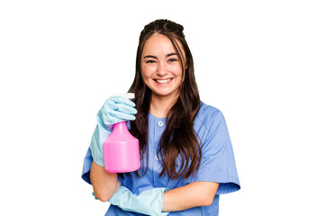 Young cleaner caucasian woman isolated on green chroma background laughing and having fun.
