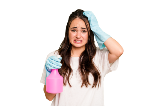 Young cleaner caucasian woman isolated on green chroma background being shocked, she has remembered important meeting.