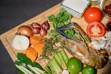 Close up the Ingredients set of TomYamKung (Shrimp Spicy Thai Soup) is a prawn, lemon condiment sauces and the others on the kitchen counter.