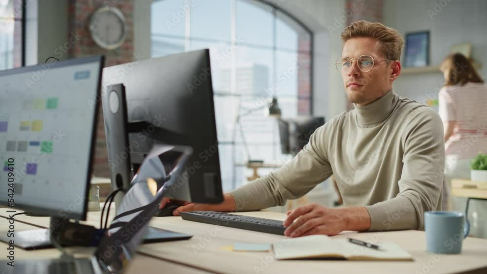 Leinwandbilder portrait of caucasian creative young man working on computer during day in modern office. supervisor