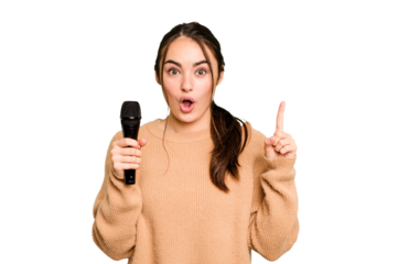 Young caucasian singer woman isolated on green chroma background having some great idea, concept of creativity.