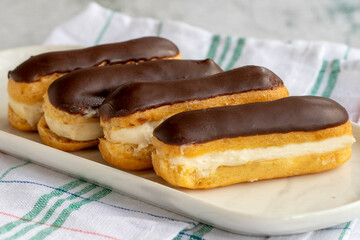 Chocolate eclair cake on gray background. Bakery products. close up