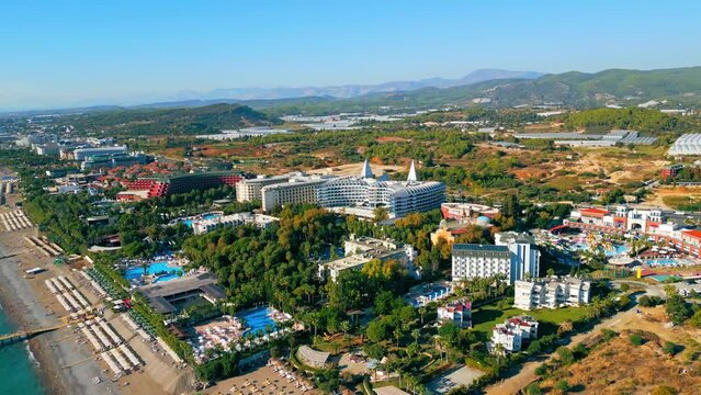 ascending view of hotels, pools and beaches surrounded with palm trees, the best place for summer holidays, Okurcalar, Turkey. High quality 4k footage