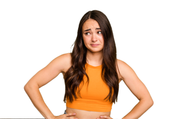 Young caucasian woman isolated on green chroma background confused, feels doubtful and unsure.