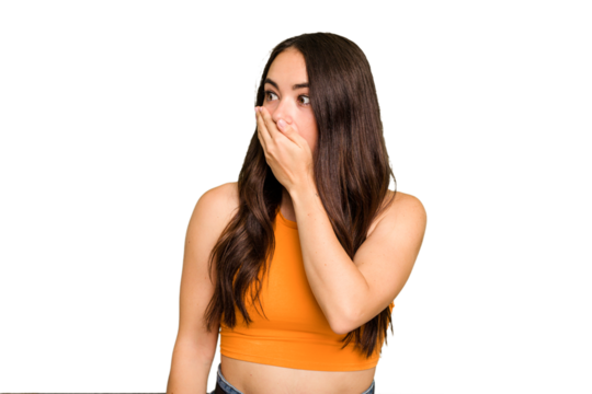 Young caucasian woman isolated on green chroma background thoughtful looking to a copy space covering mouth with hand.