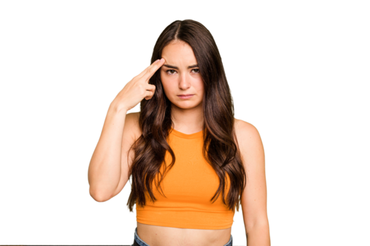 Young caucasian woman isolated on green chroma background pointing temple with finger, thinking, focused on a task.