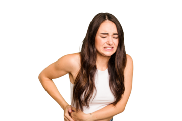 Young caucasian woman isolated on green chroma background having a liver pain, stomach ache.