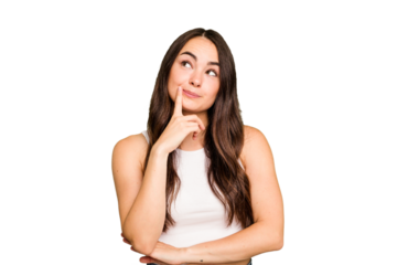 Young caucasian woman isolated on green chroma background contemplating, planning a strategy, thinking about the way of a business.