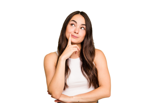 Young caucasian woman isolated on green chroma background contemplating, planning a strategy, thinking about the way of a business.