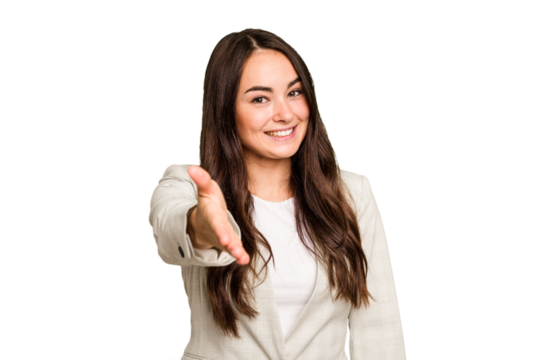 Young caucasian woman isolated on green chroma background stretching hand at camera in greeting gesture.