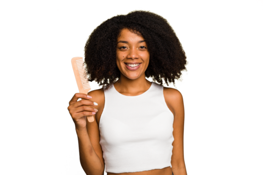 Young african american woman holding hair comb isolated happy, smiling and cheerful.