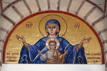 Colourful mosaic hagiography of Mother of God ,on the facade above the entrance of the church of Panagia Giatrissa in Loutraki, Greece 