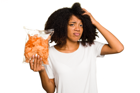 Young African american man holding crips isolated being shocked, she has remembered important meeting.