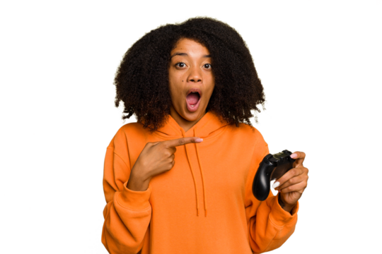 Young African American woman holding a game controller isolated pointing to the side