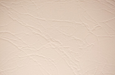 Brown background from decorative plaster with abstract spots. Unusual beige wall texture with beautiful patterns, creative surface background. Front covering for facing of buildings.