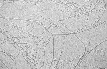 Light background of decorative plaster with abstract spots. Unusual texture of white or gray wall with beautiful patterns, creative surface background. Finishing coating for building cladding.