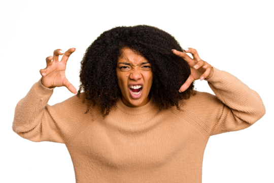 Young African American woman isolated showing claws imitating a cat, aggressive gesture.