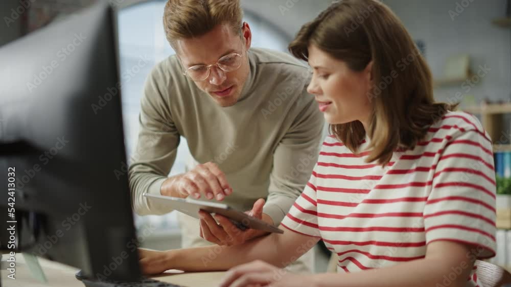 Aufkleber Portrait of Two Creative Young Colleagues Consulting Eachother Using Computer and Tablet. White Male Supervisor Discussing Scheduling with Female Caucasian Head of Operations. Slow Motion.