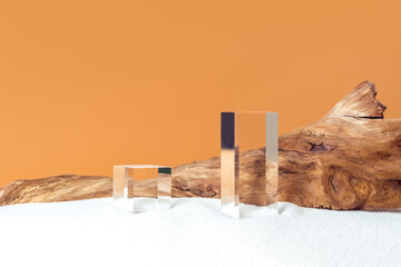 Mockup stage for advertising made with transparent acrylic cubes and weathered snag on a sandy...