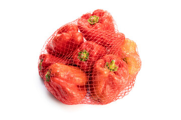 Red pepper on net bag isolated on white background
