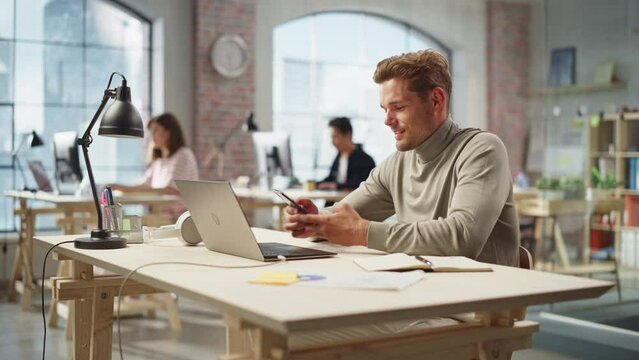 Portrait of Caucasian Productive Young Man Working on Laptop in an Active Office. White Businessman Developing an E-commerce Strategy. Busy Colleagues Working in the Background. Time Lapse Shot.