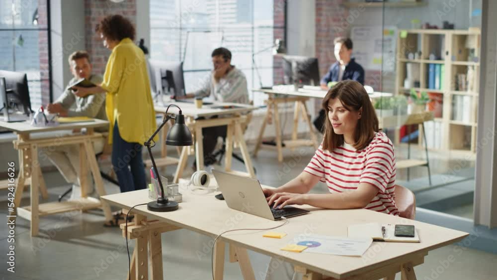 Poster group of diverse creative team members using computers in an active contemporary office. young femal