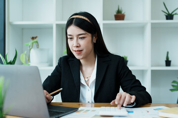 Accountants, Asian auditors are using calculators and computers to review annual tax budgets to submit information to the IRS.