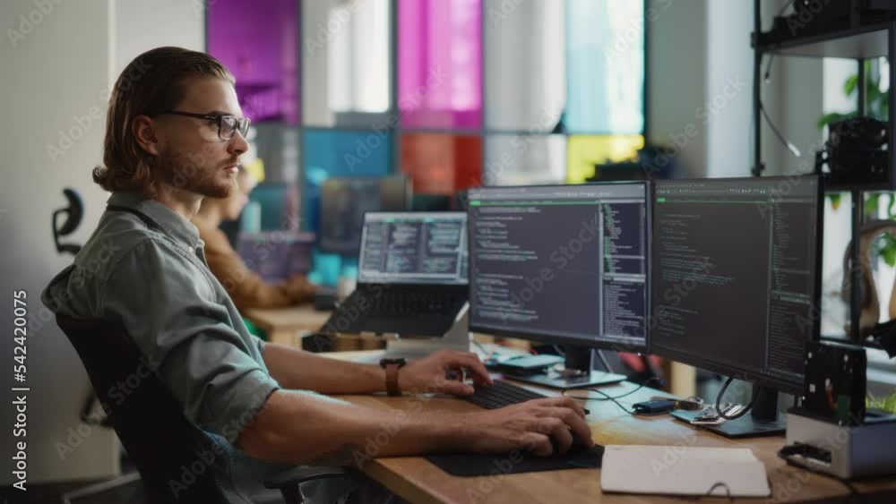 Fototapete Male Programmer Using Desktop Computer And Laptop To Write Code In Creative Office. Caucasian Man Using Multiple Displays Set Up. Developing Software As A Service Platform For Innovative Start-Up.