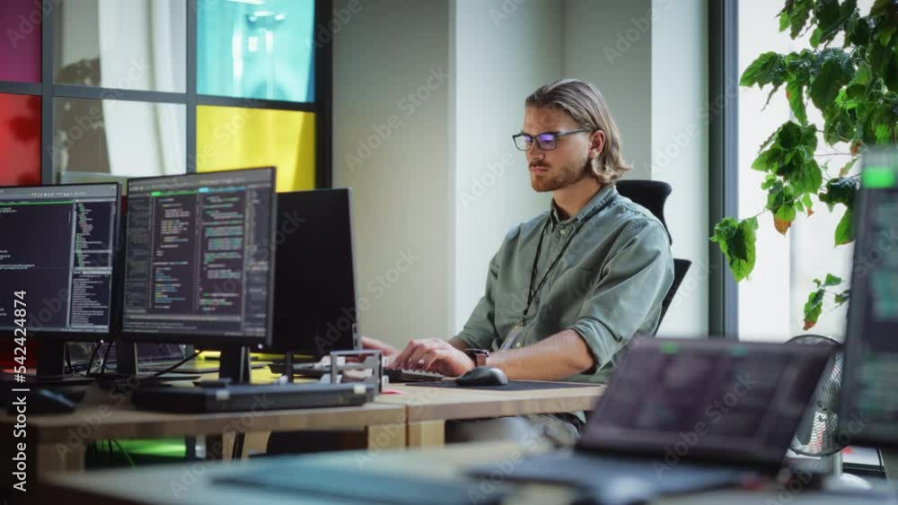 Poster Focused Caucasian Man Coding On Desktop Computer in Stylish Office Space. Male Software Engineer Developing Innovative Application For Business Customers in Technological Start-up Company.