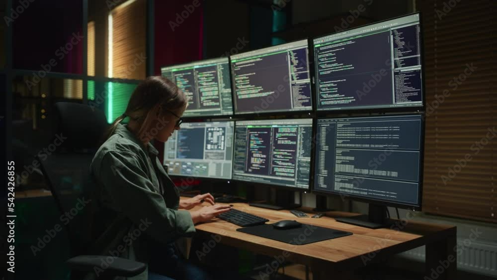Aufkleber Female Programmer Coding on Desktop Computer With Six Monitors Setup in Dark Office. Smart Caucasian Woman Monitors Data Protection System For Cyber Security Department IT Company