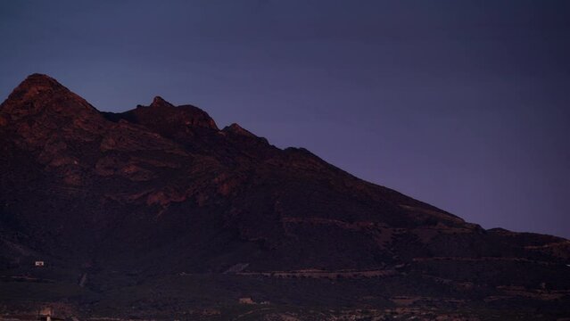 Timelapse of evening light getting dark over mountain landscape, Sierra de las Moreras in Murcia, Mediterranean region in Spain