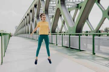 Young woman doing stretching in city, preparing for run, healthy lifestyle and sport concept.