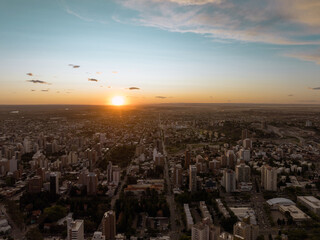 Naklejka na ściany i meble Sun falling dawn in the city. Aerial drone view at sunset