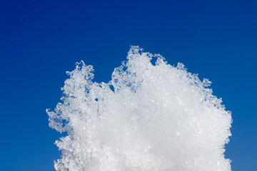 white snow against a blue background