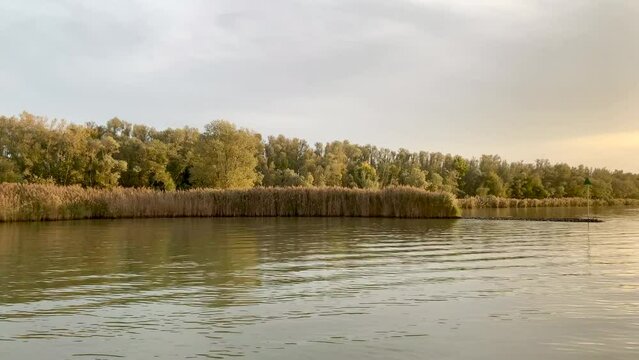 Crossing the river Merwede on a ferry at sunset