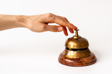 Metal golden hotel service bell with hand. Attention concept