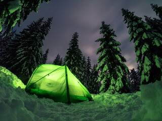 winter camping into the mountains under the sky full of stars