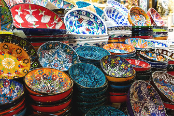 Stack of classical traditional Turkish ceramics, handmade colorful dishes at the Istanbul Grand...