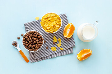 Children breakfast with snack - cereals with oranges, top view