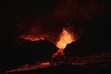 View of erupting lava in the darkness.