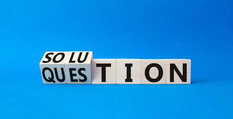 Solution and Question symbol. Turned wooden cubes with words Question and Solution. Beautiful blue background. Business and Solution and Question concept. Copy space