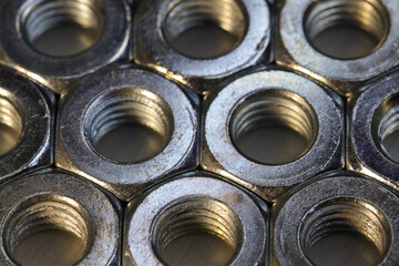 Organized Threaded Metal Hex Nuts On Flat Surface