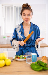 Portrait of housewife with rolling pin