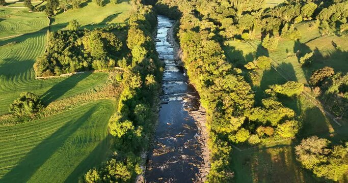 Flying above river going through the English countryside