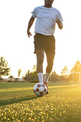Football player on the field running with the ball. Close up of player's feet running with the ball...